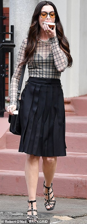 Her lingerie matched her pleated skirt, which fell past the knee and was cinched in at the waist, emphasizing her enviably slender frame