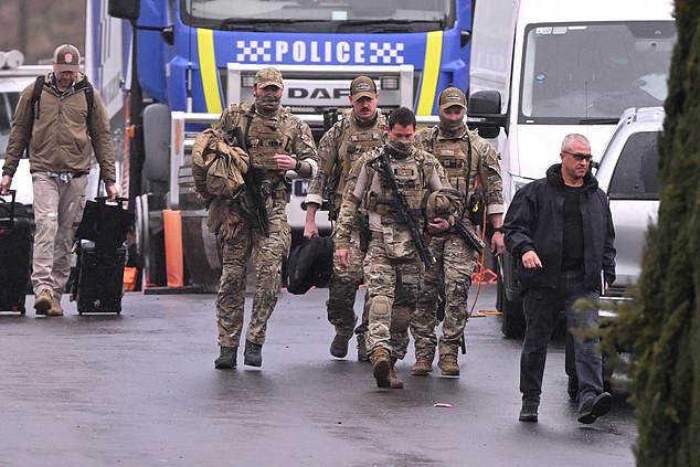 Heavily armed police gather at a police staging point during the search for a fugitive linked to the murder of two police officers, in Porepunkah on August 28, 2025. Police searched the Australian bush for a heavily armed 56-year-old gunman still on the run a day after allegedly killing two officers and wounding a third. (Photo by William WEST / AFP) (Photo by WILLIAM WEST/AFP via Getty Images)