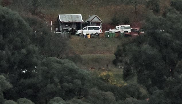 A police vehicle parks outside a property as the search intensifies for a fugitive linked to the murder of two police officers in Porepunkah on August 27, 2025. Police searched the Australian bush on August 27, for a heavily armed 56-year-old gunman still on the run a day after allegedly killing two officers and wounding a third. (Photo by William WEST / AFP) (Photo by WILLIAM WEST/AFP via Getty Images)
