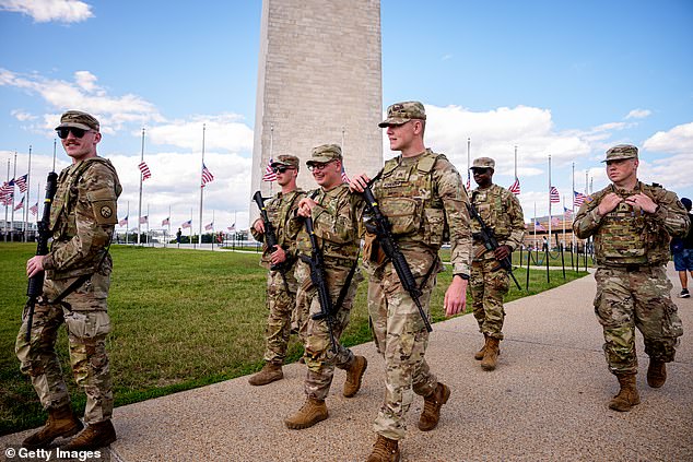 The Washington Monument is visible as armed members of the National Guard patrol the National Mall on August 27, 2025 in Washington, DC. The Trump administration has deployed federal officers and the National Guard to the District in order to place the DC Metropolitan Police Department under federal control and assist in crime prevention in the nation's capital