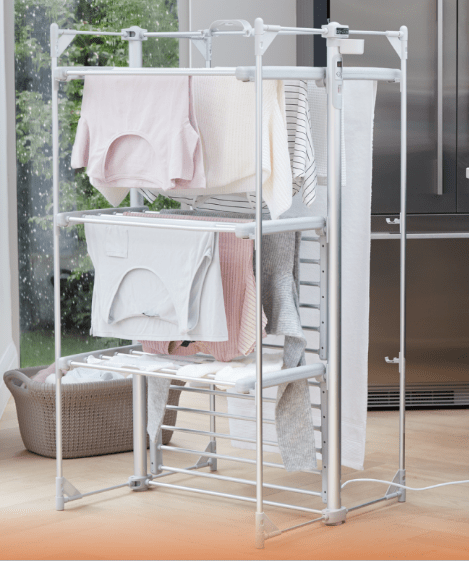 Electric heated clothes drying rack with laundry.