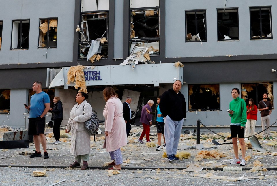 People stand outside a damaged British Council building in Kyiv, Ukraine.