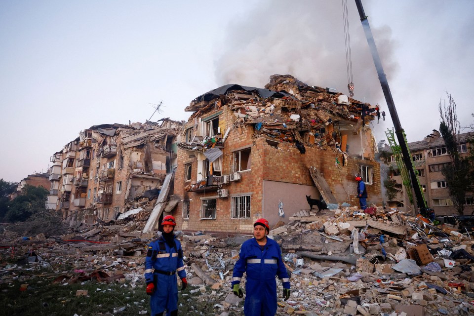 Rescuers at the site of a building hit by missile strikes in Kyiv, Ukraine.