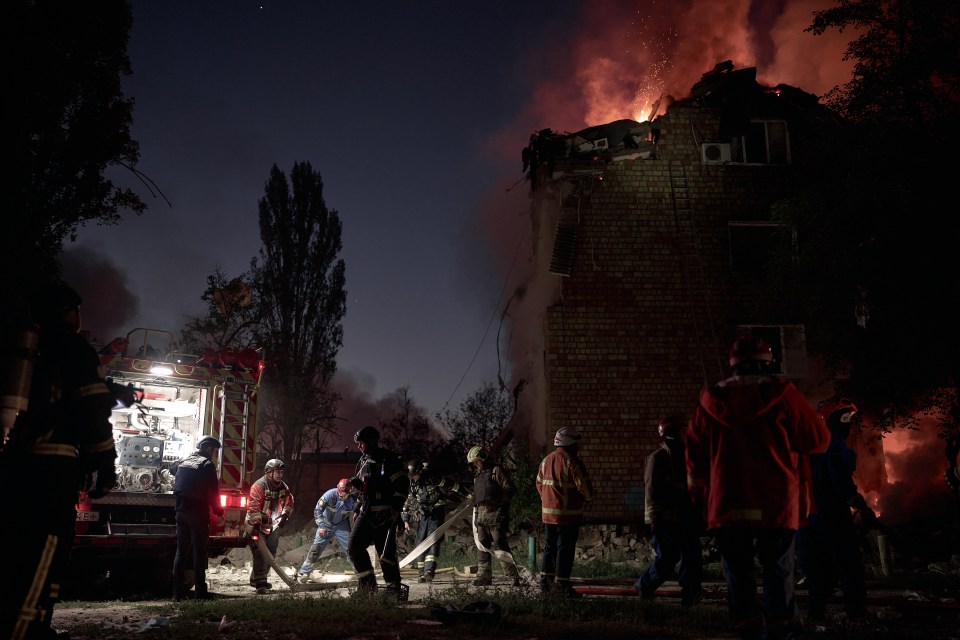 Rescuers at the site of a burning building in Kyiv, Ukraine.