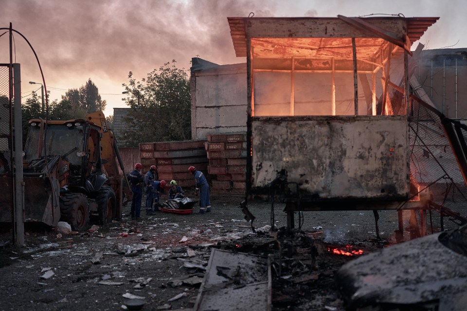 Rescuers recovering a body from a burning building in Kyiv, Ukraine.