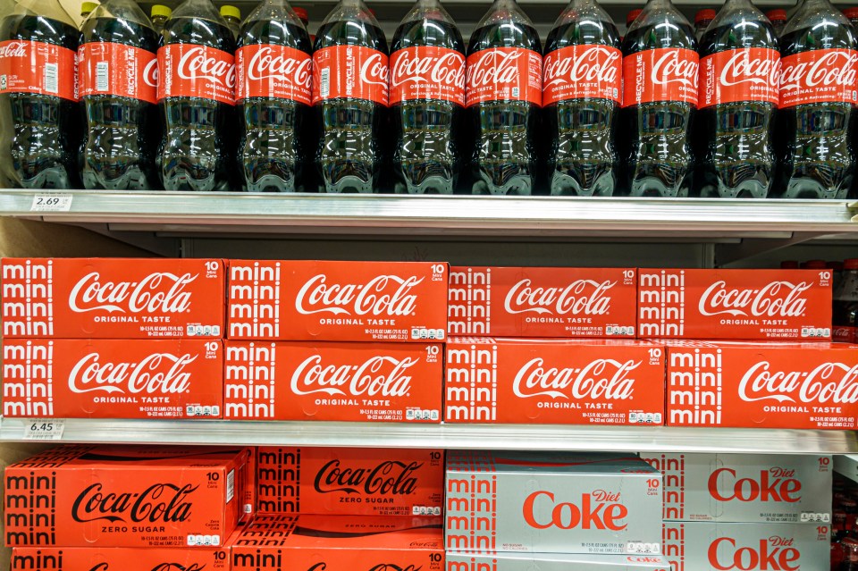 Coca-Cola products on shelves in a Publix grocery store.
