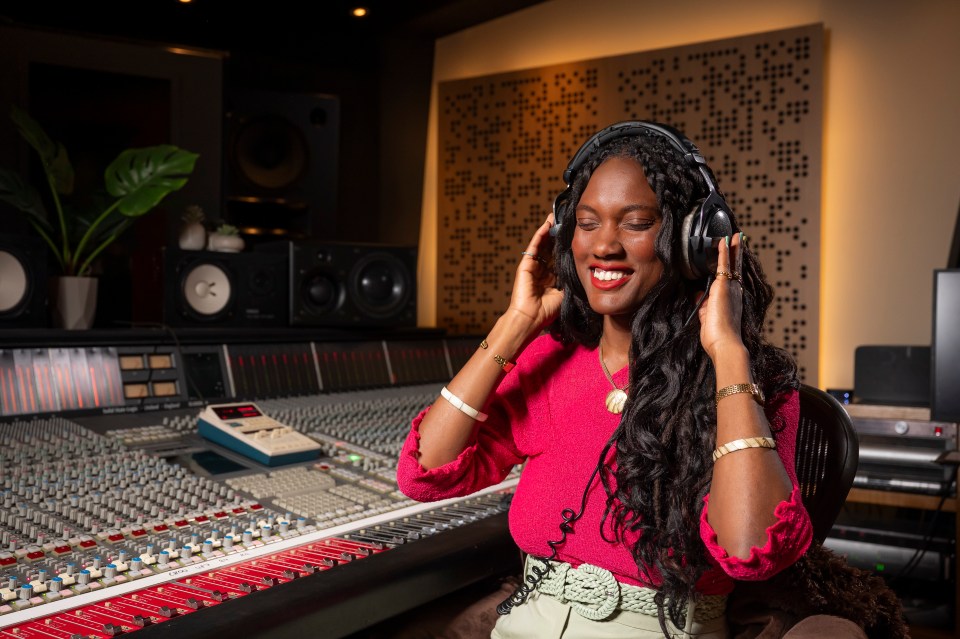 Composer Dr. Natalie Hyacinth listening to music in a recording studio.