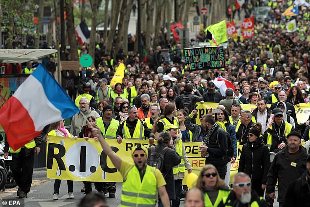 Protesters from the 'Gilets Jaunes' (Yellow Vests) movement march through Paris' streets on 27 April 2019