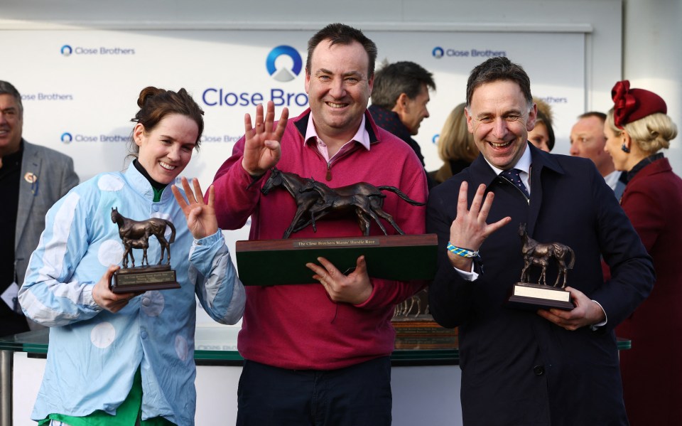 Winning team holding trophies at a horse race.