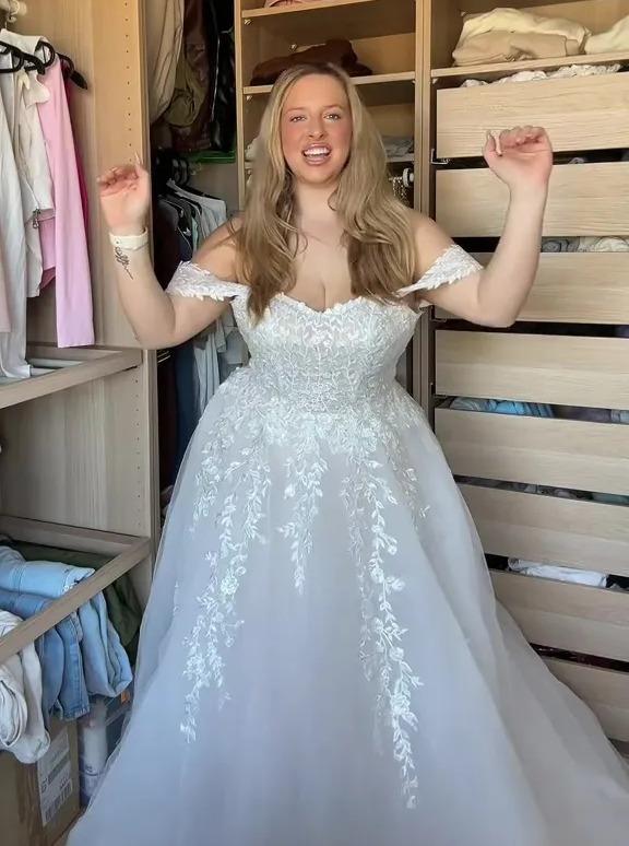 Woman in wedding dress in a closet.