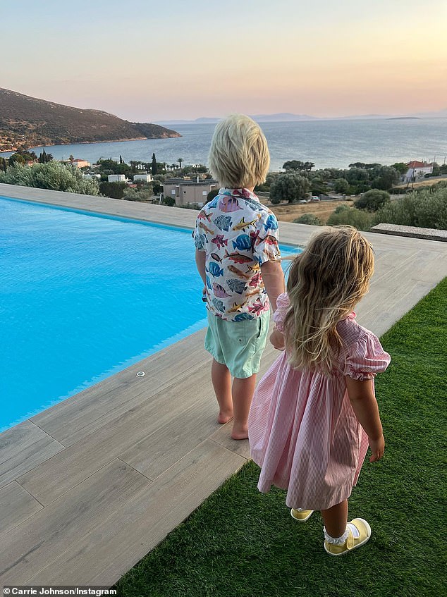 Five-year-old Wilfred holds hands with his sister Romy, three, during the family holiday