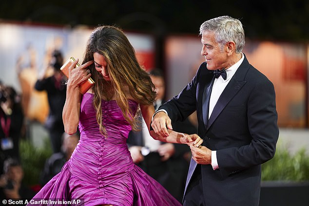 The star, who is 64, arrived at around 9.35pm local time for the 9.45 premiere of his new Netflix film Jay Kelly with his wife Amal