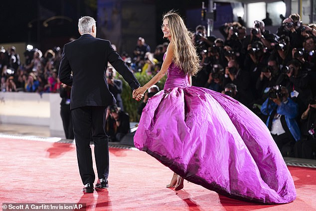 Amal's dress flowed behind her in a dramatic train