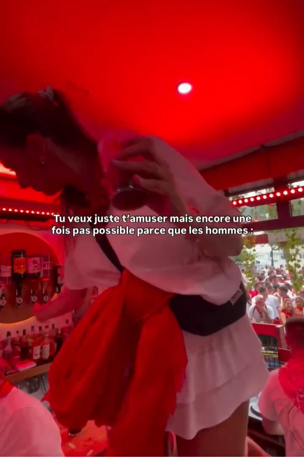 A woman's skirt is lifted up by a man at a bar.