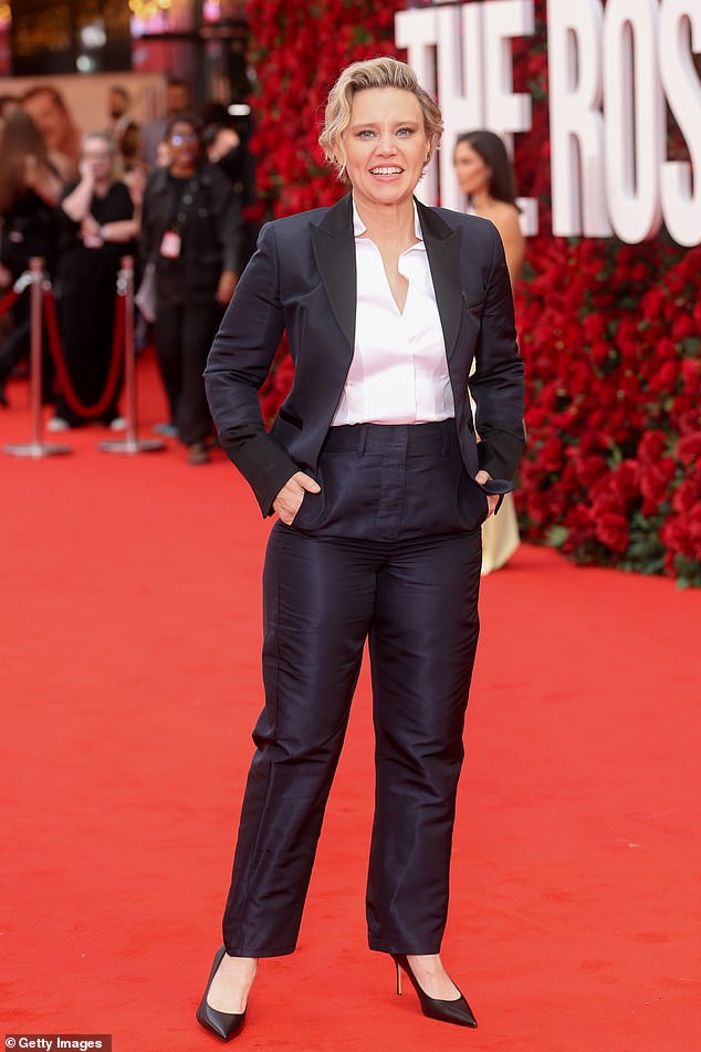 Kate McKinnon opted for a black business suit and white shirt, as well as black Marion Parke stilettos
