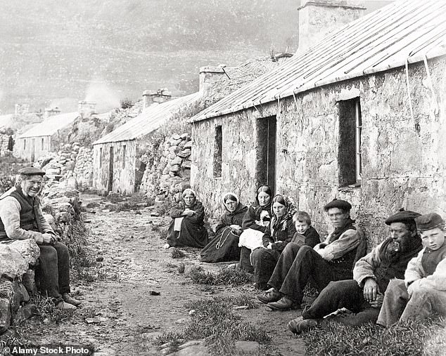 Residents of St Kilda pose for a photograph along one of the island's cobbled streets