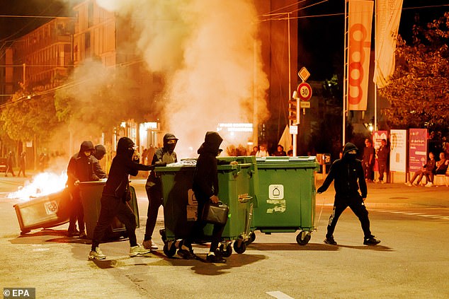 Protesters burn containers during the second night of riots following the fatal accident involving a minor on a scooter in Lausanne, Switzerland, 25 August 2025