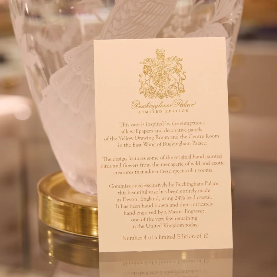 Close-up of a card describing a Buckingham Palace limited edition crystal vase.