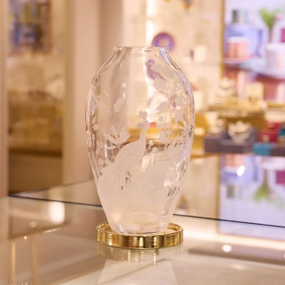 Crystal vase with etched birds and flowers.