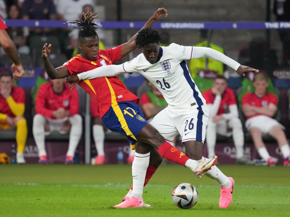 Spain's Nico Williams and England's Kobbie Mainoo vying for the ball during a soccer match.