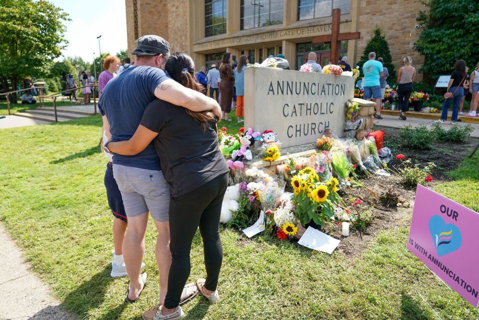 Annunciation School exterior with emergency personnel and vehicles.