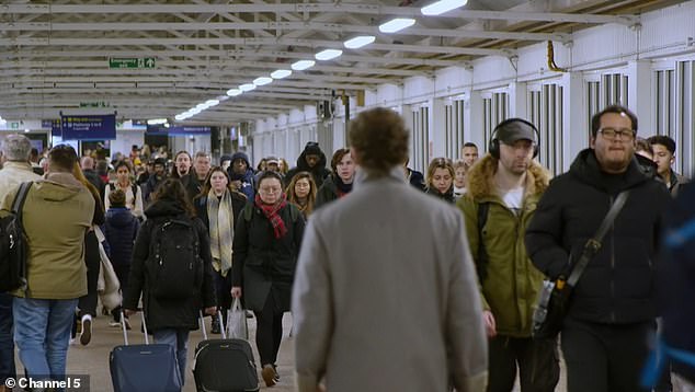 The team hold a 'revenue block' on the overbridge between platforms at Clapham Junction