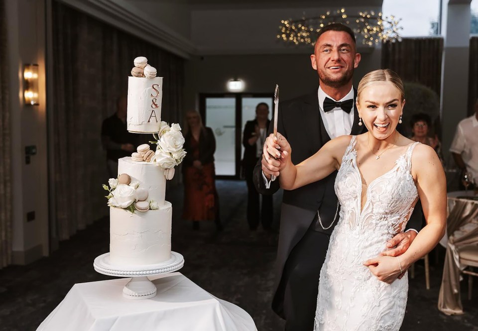 Bride and groom cutting their wedding cake.