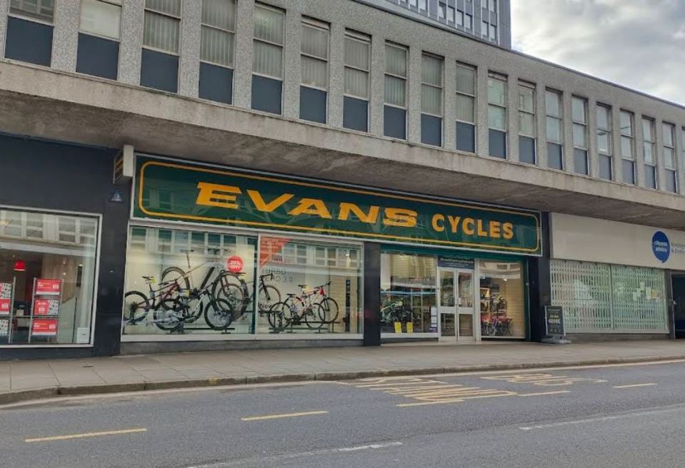 Evans Cycles storefront with bicycles displayed in the window.