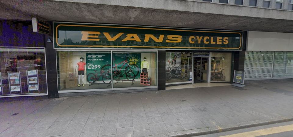 Evans Cycles shop storefront with bicycles in the window.