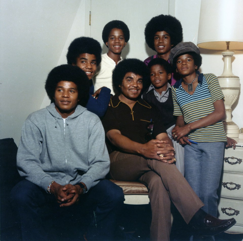 The Jackson 5 with their father and youngest brother.