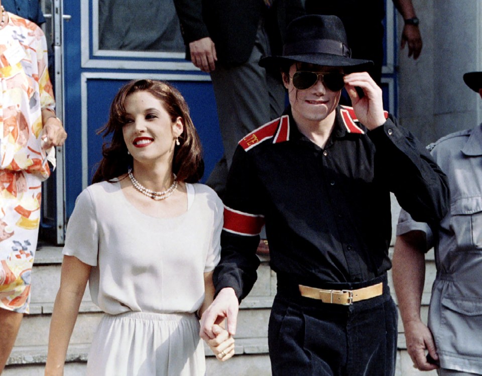 Michael Jackson and Lisa Marie Presley holding hands.
