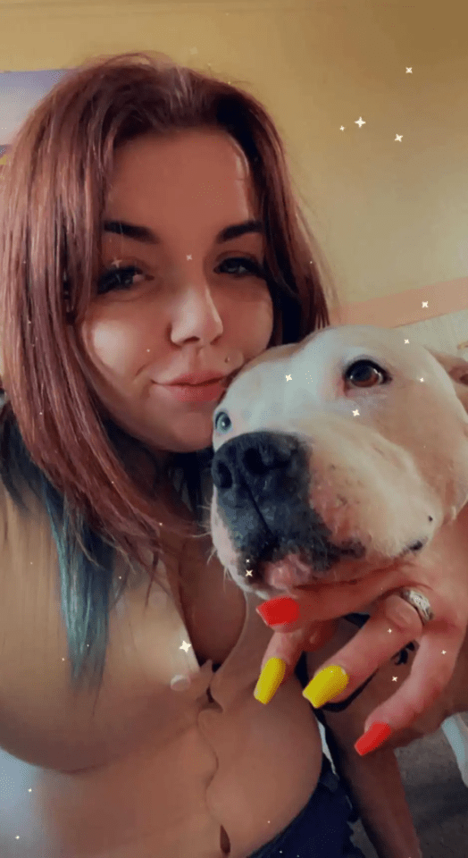 Woman cuddling with her white dog.