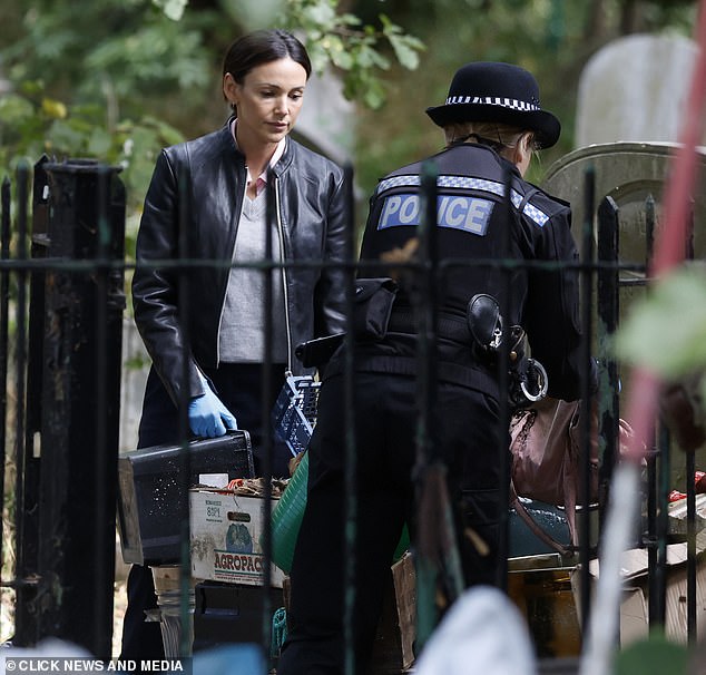 The stunner searched through rubbish in one shot, looking to find clues in the drama