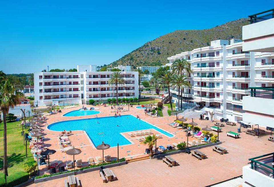 Aerial view of a resort pool and surrounding buildings.