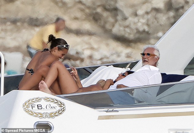 He was pictured alongside two women who were seen in skimpy bikinis that set pulses racing