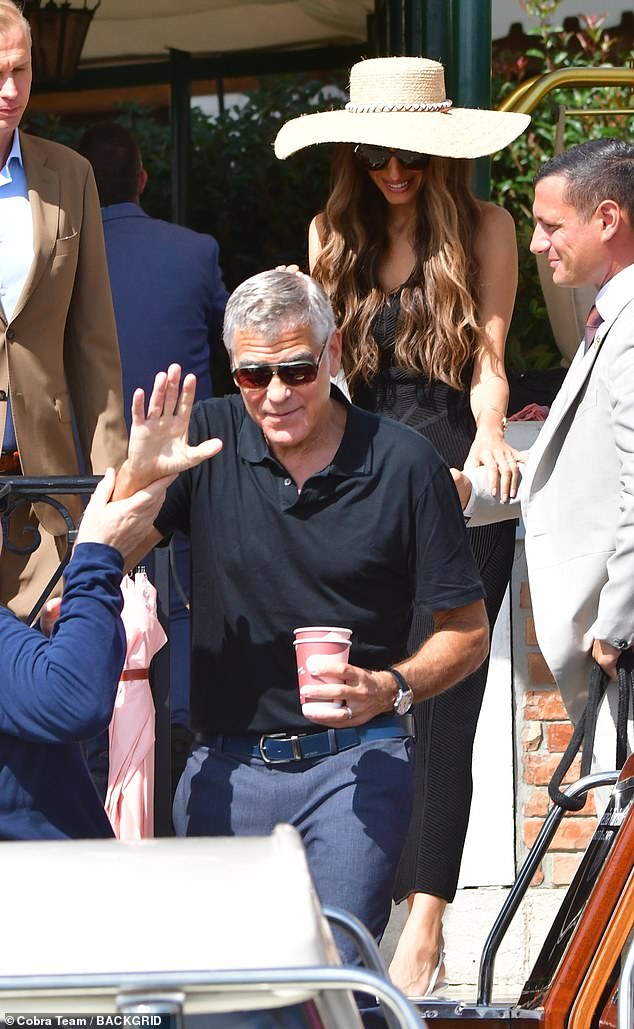 Amal stole attention wearing a stunning black ensemble with an oversized straw hat as she carried a cup of coffee in hand