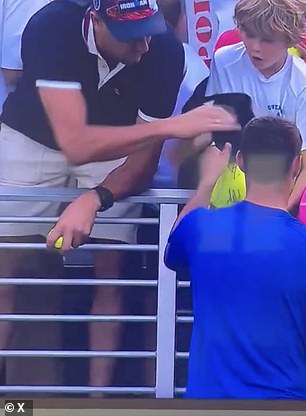He tried to give his cap to a young boy, but a man snatched it away