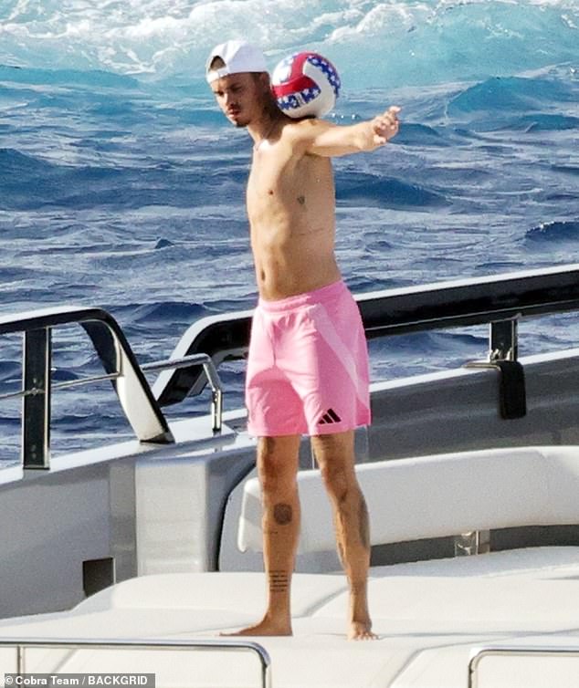 Romeo, 22, who turned his back on football last year to sign with a top Paris fashion agency, looked in great spirits on their holiday as he larked around with the ball on the deck