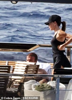 Victoria, 51, showcased her toned figure in a skintight black top with a cut out along the back