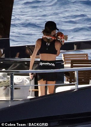 She added to the look with a Reebok skirt and baseball cap