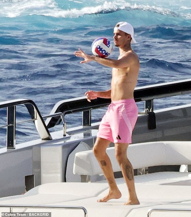 Romeo displayed his various tattoos as he went shirtless in a pair of pink swimming trunks
