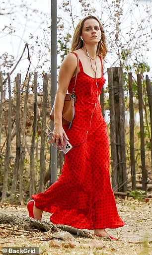 Emma teamed the stunning dress with matching red pumps