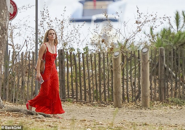 Emma appeared in good spirits as she walked along the coastline