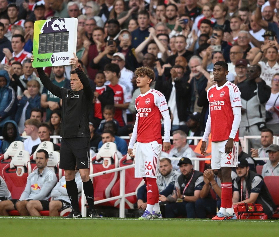 Arsenal players preparing to enter a Premier League match.