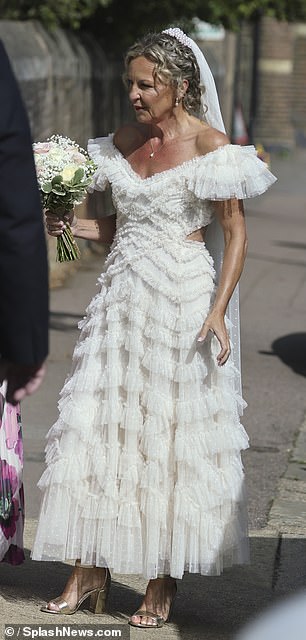 The actress showcased her new wedding band as she clutched her bouquet and sipped champagne with guests following the ceremony