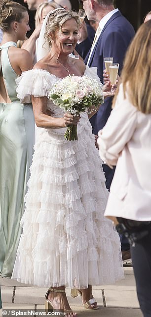 The actress showcased her new wedding band as she clutched her bouquet and sipped champagne with guests following the ceremony