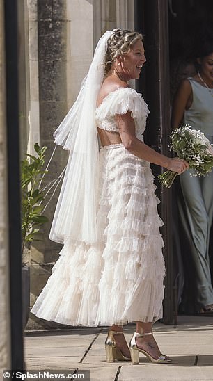 The actress showcased her new wedding band as she clutched her bouquet and sipped champagne with guests following the ceremony