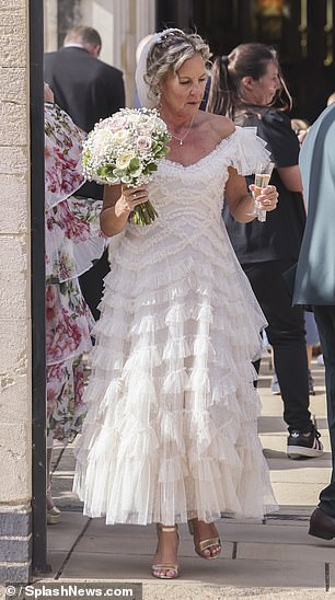 The actress showcased her new wedding band as she clutched her bouquet and sipped champagne with guests following the ceremony