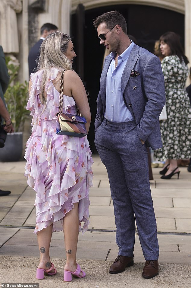 She wore a pair of striking pink sandals and carried her essentials in a metallic shoulder bag