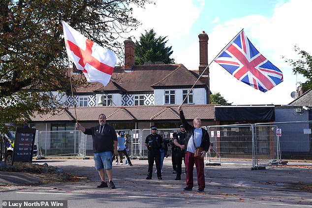 Protesters wave flags outside the Bell Hotel following the major ruling on Friday